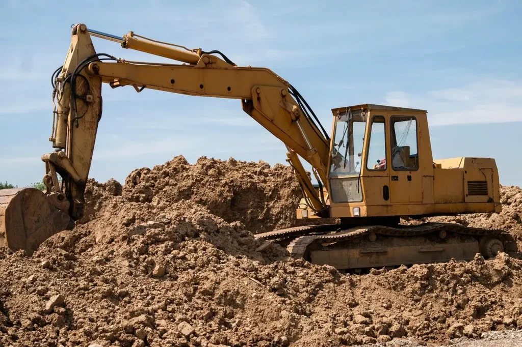 A picture of a digger on a pile of muck. It's just a stock photo but mostly accurate. In real life the digger driver would just sit in there and have a snooze.